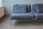 Old Modern Blue Chair On Dirty Carpet Floor Stock Photo