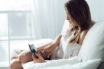 Beautiful Young Woman Using Her Mobile Phone At Home Stock Photo