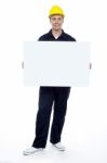 Young Worker Holding Blank Board Stock Photo