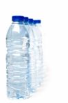 Row Of Plastic Water Bottles Isolated On A White Background Stock Photo