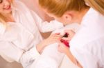 Beautician Applying Nail Varnish To Woman Stock Photo