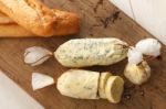 Baguette With Herb Butter And Rosemary Thyme On Rustic Wooden Background Stock Photo