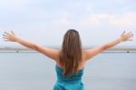 Woman Standing Back With Open Arms Stock Photo