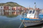 Boats Of Fishermen On The Temo River And Typical Colored Facade Of Bosa, Oristano Province, Sardinia, Italy Stock Photo