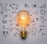 Light Bulb With Drawing Graph Stock Photo