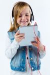 Beautiful Child Listening To Music With Digital Tablet Stock Photo