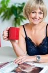 Relaxed Woman In Lingerie Enjoying Her Beverage Stock Photo