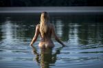 Beautiful Naked Woman Standing In Water Stock Photo