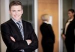 Businessman Posing With Smart Associates Behind Stock Photo