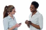 Two Corporate Women Having A Discussion Stock Photo