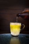 Lager Beer Drain From Bottle To Glass On Table Stock Photo