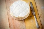 Camembert Cheese And Vintage Knife On Wooden Table Stock Photo