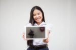 Portrait Of Thai High School Student Uniform Beautiful Girl Using Her Tablet Stock Photo