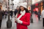 Woman In Red Coat And Wool Cap And Gloves With Smartphone In Han Stock Photo