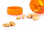 Closeup Of Orange Pills And Pill Bottle Stock Photo