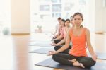 Asian Woman Doing Yoga Indoors Stock Photo