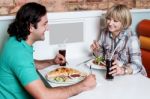 Couple Enjoying Dinner At A Restaurant Stock Photo