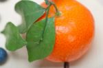 Tangerine And Blueberry On White Table Stock Photo