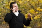 Young Man Talking On Cellphone At Park Stock Photo