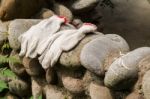 Gloves Workers Were Left On A Stone Wall Stock Photo