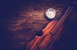 Violin And Pocket Watch On Grunge Dark Wood Background Stock Photo