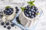 Blueberry Basket And Jug On White Wooden Table Stock Photo