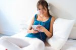 Beautiful Girl Listening To Music With Tablet On Sofa At Home Stock Photo