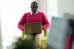 Handsome Young Man Working With His Laptop At Home Stock Photo