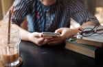 Woman Using Phone In Cafe Stock Photo