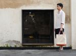 Man With Canvas Bag On Grunge Concrete Background Stock Photo