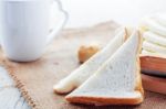 Bread And Cup On Table Stock Photo