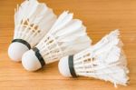 Close Up White Shuttlecock On Wooden Background Stock Photo