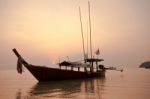 Boat In Ocean At Sunrise Stock Photo