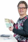 Elderly Woman Counting And Showing Money Stock Photo