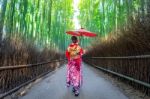 Bamboo Forest. Asian Woman Wearing Japanese Traditional Kimono At Bamboo Forest In Kyoto, Japan Stock Photo