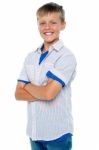 Smiling Young Boy With Crossed Arms Stock Photo