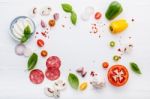 The Ingredients For Homemade Pizza On White Wooden Background Stock Photo