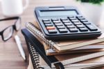 Office Desk With Calculator Stock Photo