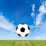 Soccer Ball With Soccer Field Against  Blue Sky Background Stock Photo