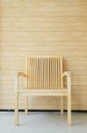 Wooden Chair With Wooden Wall In Background Stock Photo