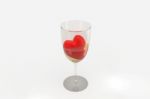 Red Heart Dug In Wine Glass Stock Photo