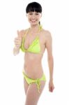 Glamorous Bikini Model Showing Thumbs Up Stock Photo