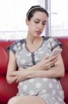 Pregnant Woman Relaxing On A Couch Stock Photo