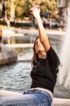 Woman Sitting  And Making Selfie Stock Photo