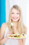 Salad On Fork And Plate Stock Photo