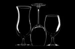 Glasses For Wine, Beer And Cocktail On Black Background Stock Photo