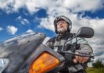 Elderly Motorcyclist Wearing A Jacket And Glasses With A Helmet Stock Photo