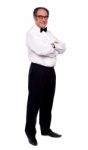 Elder Man Standing With arm Crossed Stock Photo