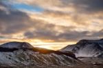 Snowy Icelandic Mountains With Dramatic Cloudy Sky Stock Photo