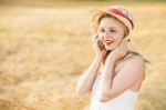 Lonely Beautiful Young Blonde Girl In White Dress With Straw Hat Stock Photo